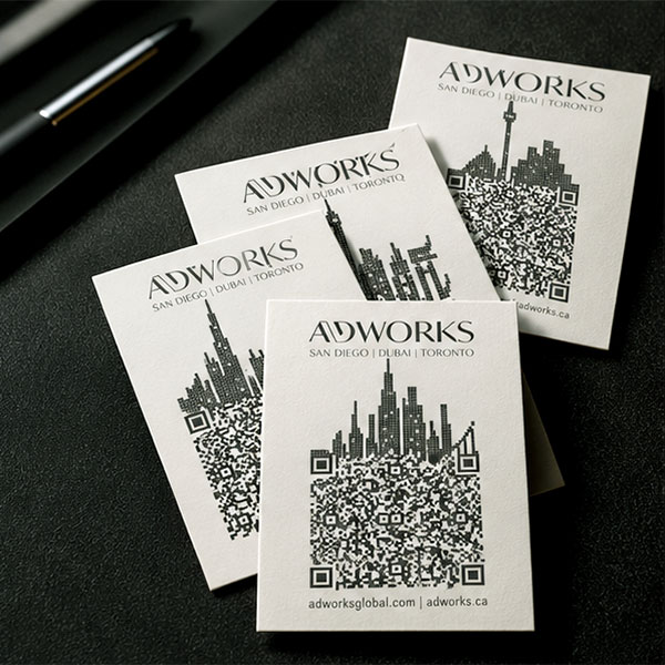 A fanned stack of ADWORKS cards showing the skyline QR backs