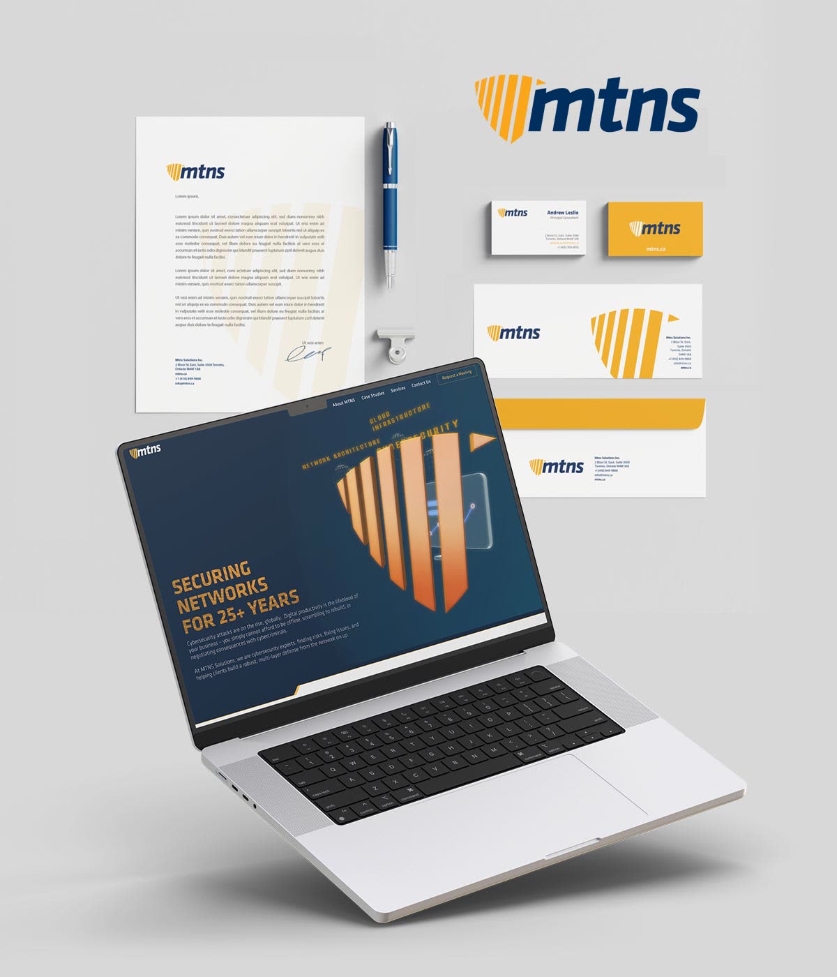 The MTNS identity together: logo, letterhead, business cards, envelopes and the website on a laptop
